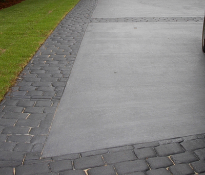 Plain concrete driveway with stamped borders.