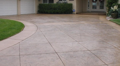 Brown stamped concrete driveway with straight square concrete cuts.