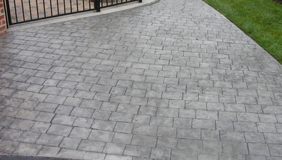 Charcoal gray stamped concrete driveway