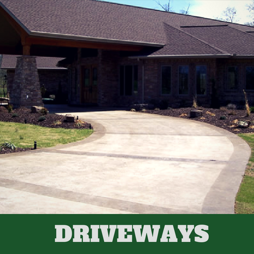 Two toned colored concrete driveway in Brentwood, TN with brick home.