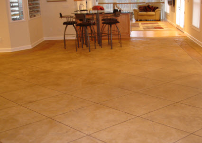 Stamped interior floor concrete cut into squares made to look like tile.