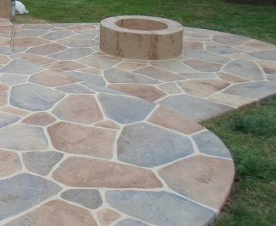 Sand stone slate stamped concrete patio with built in fire pit.