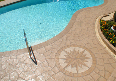 Smooth finished concrete pool deck with compass designed stamped in.