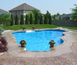 Pool deck edged in plain concrete and stamped concrete around that.