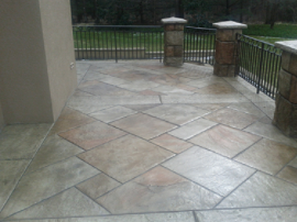 Wrap around front porch with tile stamped concrete.