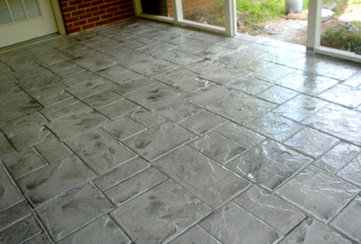 Stamped gray inside patio made to look like stone blocks.