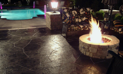 Stamped concrete patio in Brentwood with a built in fire ring.